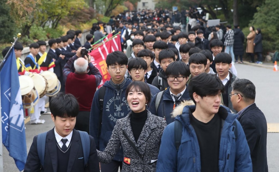 대학수학능력시험을 하루 앞둔 13일 서울 용산고등학교에서 교사와 후배 학생들이 하교하는 고3 수험생들을 응원하고 있다.