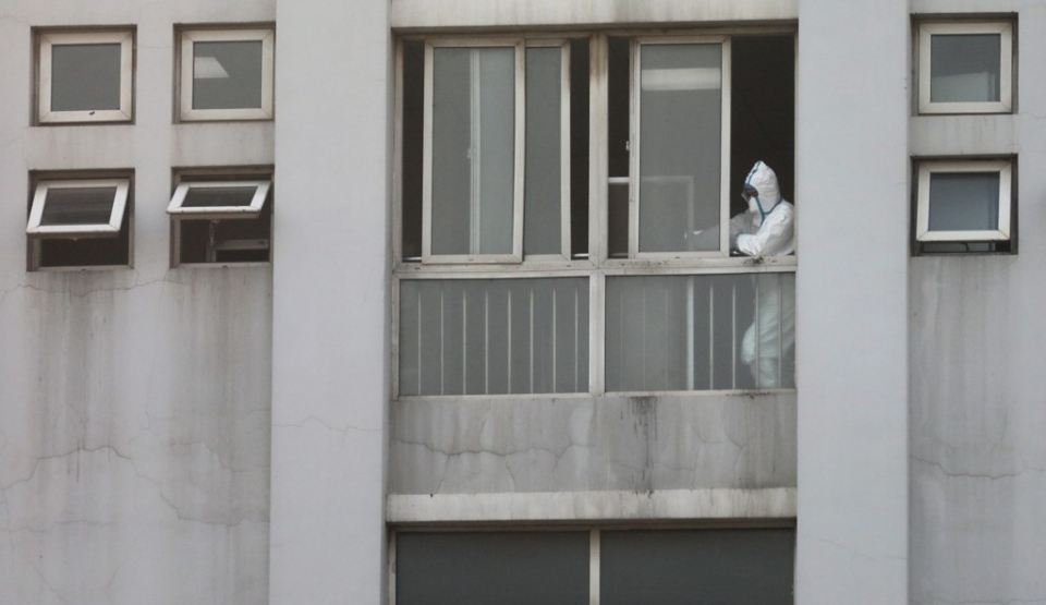 신종 코로나바이러스에 감염된 이른바 '우한 폐렴' 환자들이 치료를 받고 있는 중국 후베이성 우한의 진인탄 병원에서 보호복을 입은 의료진의 모습이 창문 옆으로 보이고 있다.
